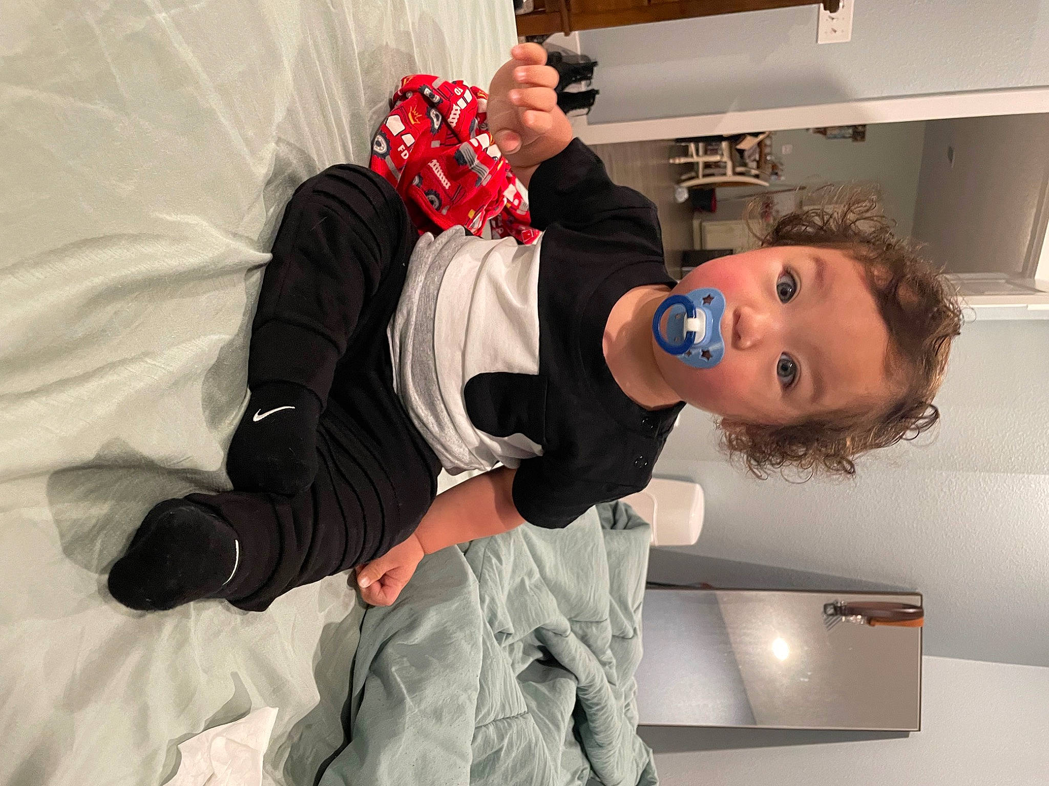 Anthony is registered to the contest to win money with this photo: animation, child, comfort, costume, event, fictional_character, flooring, fun, fur, gesture, glove, kitchen_appliance, person, refrigerator, room, sitting, surprise, textile, toddler