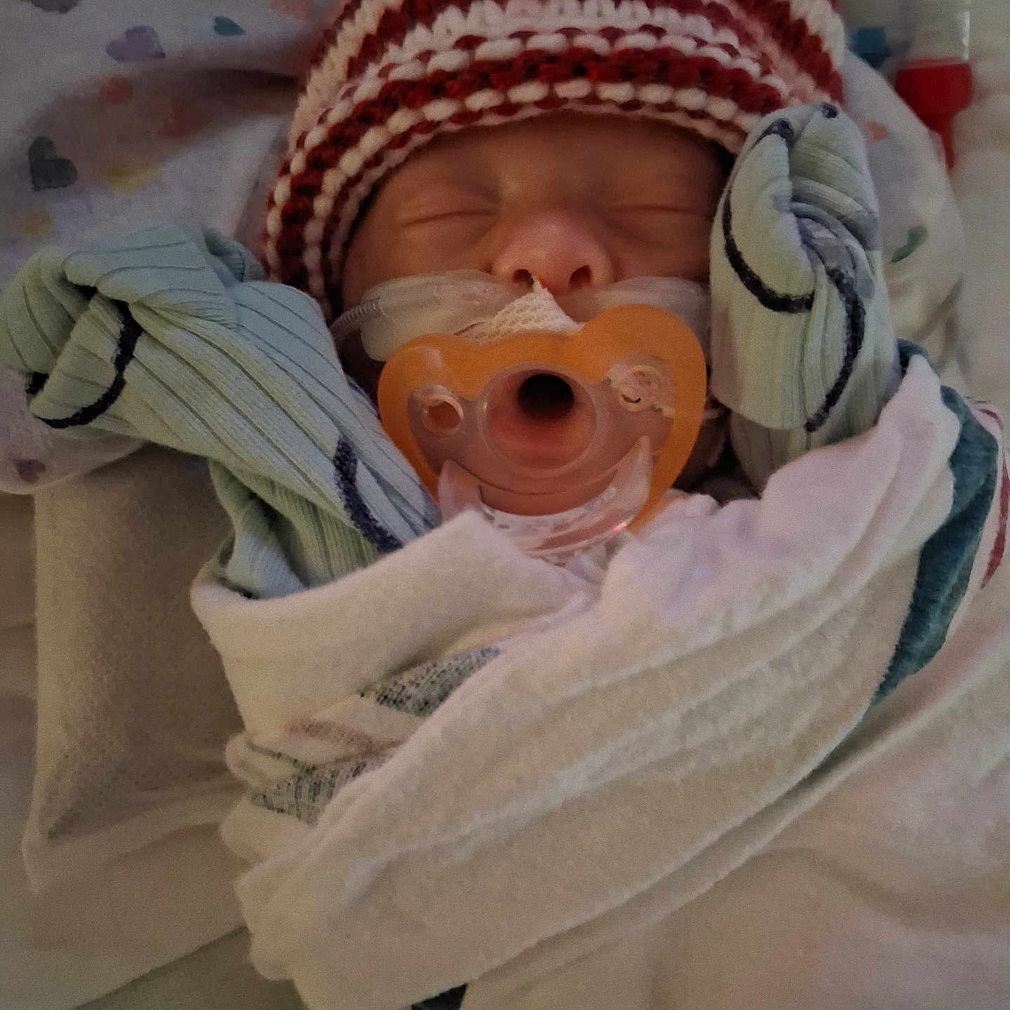 River Coleman is registered to the contest to win money with this photo: baby, bed, blanket, child, clothing, cozy, cute, face, hospital, indoors, infant, knit_hat, medical_tube, newborn, pacifier, resting, sleeping, soft, tiny, wrapped