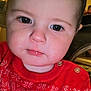 Lorenzo is registered to the contest to win money with this photo: baby, child, face, close_up, sweater, red_clothing, patterned_clothing, bird_pattern, indoor, portrait, cute, young_child, eyebrows, skin, head, person, infant, buttoned_clothing, expression, holiday