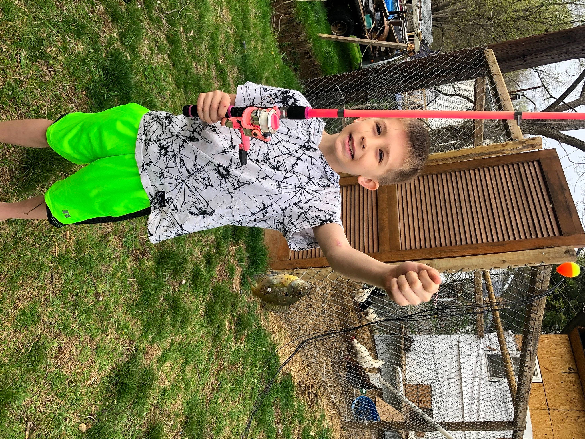 Cade joined the competition — help win amazing prizes! boot, child, folk_instrument, fun, grass, joy, leisure, musical_instrument, outdoor_furniture, pattern, people_in_nature, person, plant, recreation, sandal, sitting, thigh, tree, wood, yard