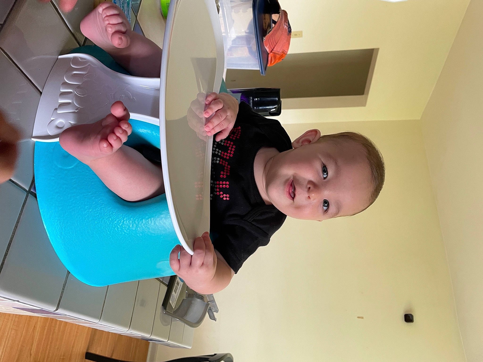 Sawyer is registered to the contest to win money with this photo: art, baby, baby_products, ceiling, chair, child, comfort, elbow, finger, fun, gesture, hand, happy, lighting_accessory, person, play, room, sitting, t_shirt, thigh