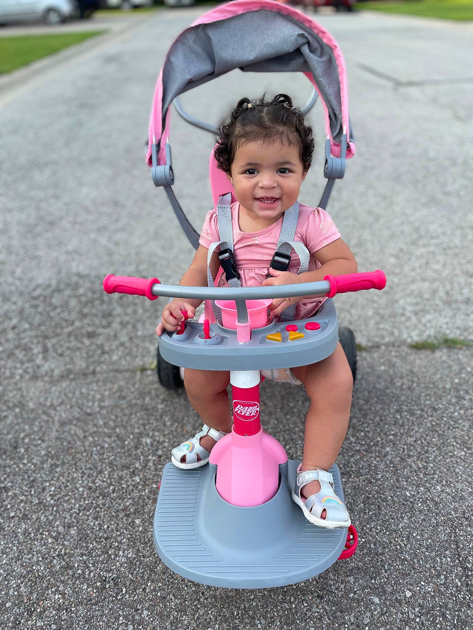 Amariana joined the competition — help win amazing prizes! asphalt, baby, baby_carriage, child, fun, grass, joy, leisure, musical_instrument, person, pink, plant, recreation, riding_toy, shorts, smile, sneakers, tire, toddler, toy