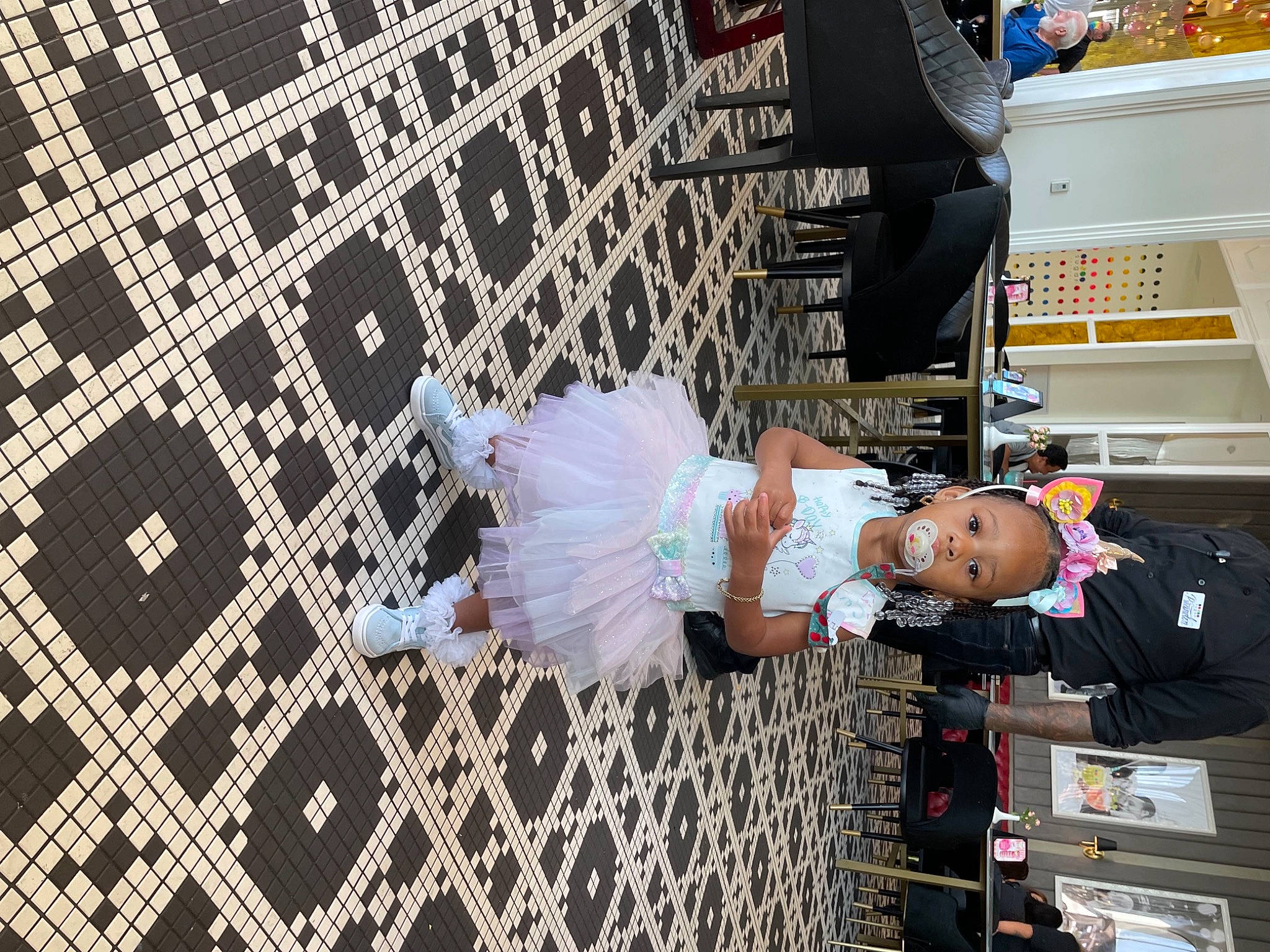 Loyaltie is registered to the contest to win money with this photo: arm, child, clothing, costume, design, entertainment, event, flooring, fun, pattern, pedestrian, person, product, room, street, street_fashion, toddler, tree