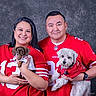 Hermione joined the competition — help win amazing prizes! couple, man, woman, dog, small_dog, pet, football_jersey, red_clothing, smiling, portrait, studio, indoor, team_spirit, fan, holding_pet, happy, cute, animal, togetherness, casual