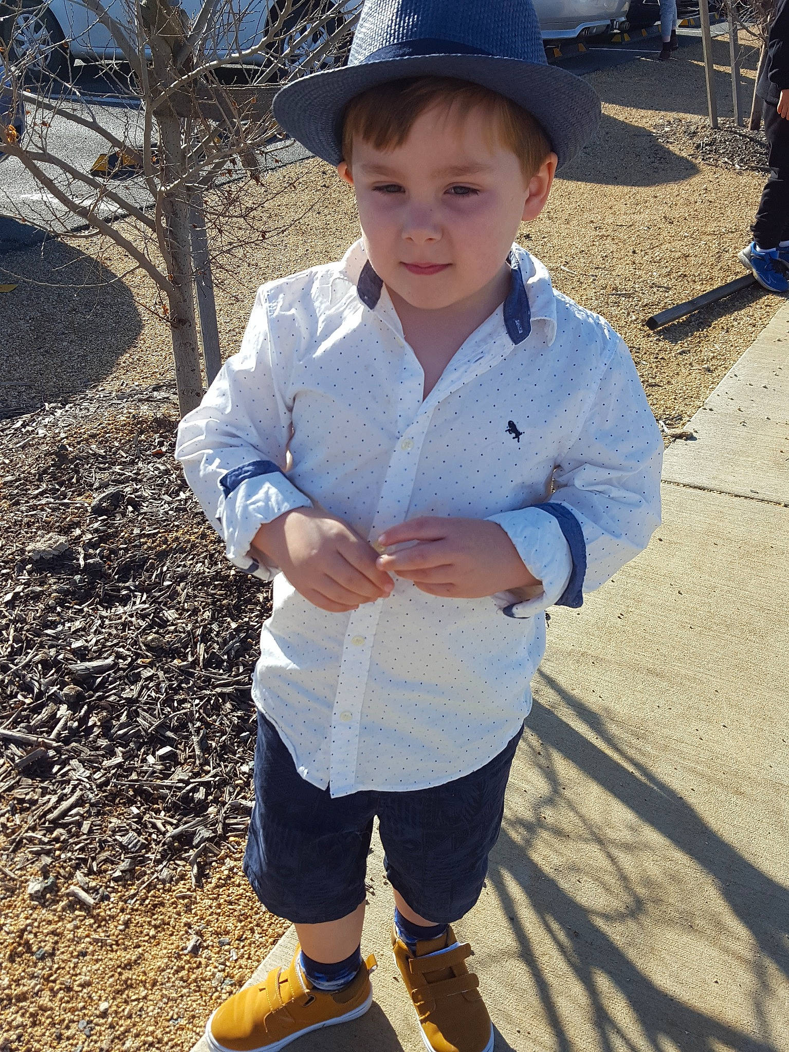 Jai is registered to the contest to win money with this photo: child, fashion_accessory, footwear, fun, games, hat, headgear, holiday, male, outerwear, person, plant, recreation, shadow, shoe, sleeve, smile, soil, toddler, tree