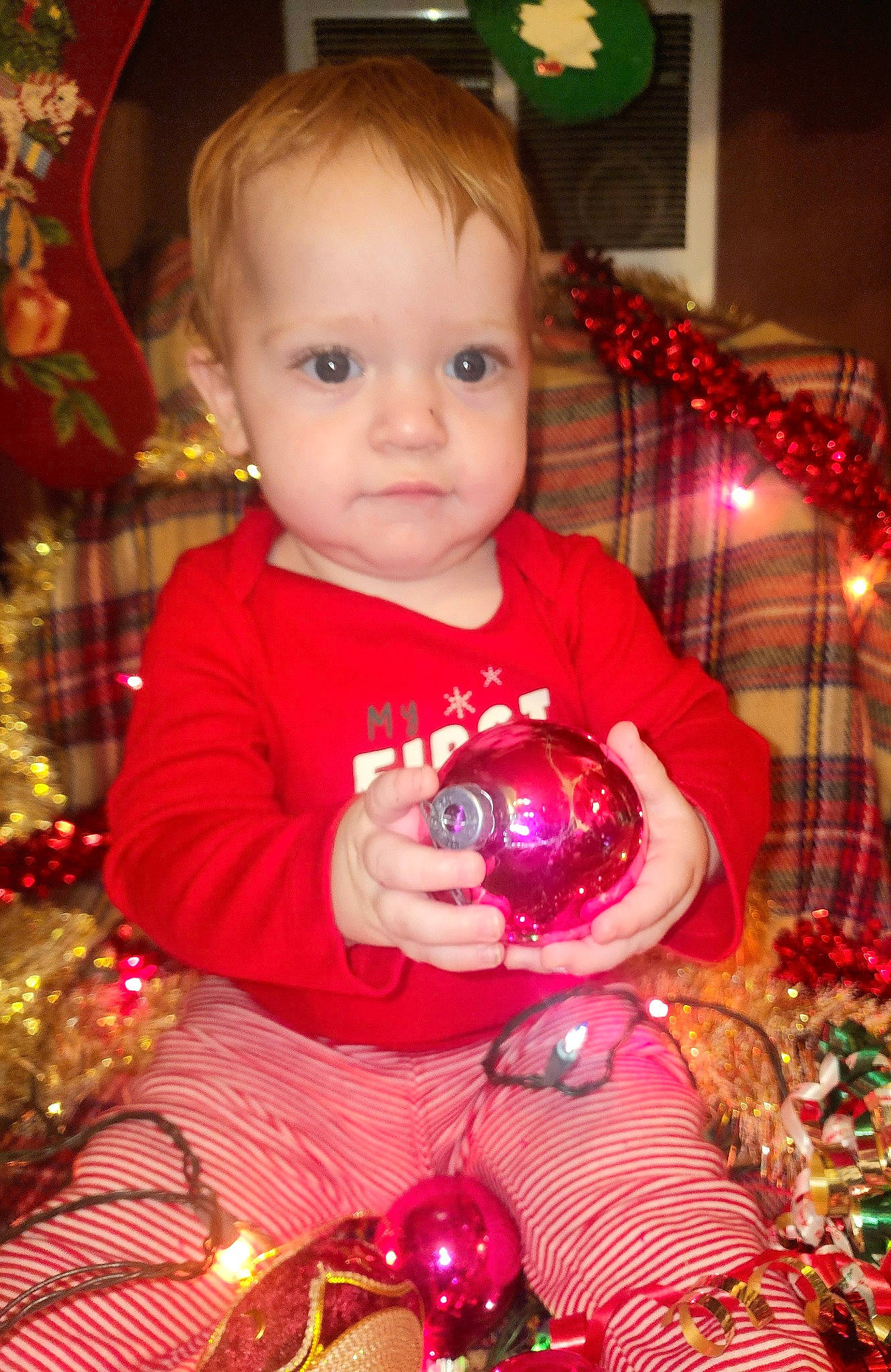 Dominick is registered to the contest to win money with this photo: baby, baby_toddler_clothing, cheek, christmas, christmas_decoration, christmas_ornament, christmas_tree, event, fun, green, happy, head, holiday, holiday_ornament, iris, light, ornament, person, red, tartan