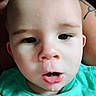 Apollo joined the competition — help win amazing prizes! baby, infant, child, portrait, face, eyes, pout, open_mouth, tongue, teal_shirt, closeup, indoor, adult, tattoo, cuddling, skin, head, photograph, serious_expression, casual