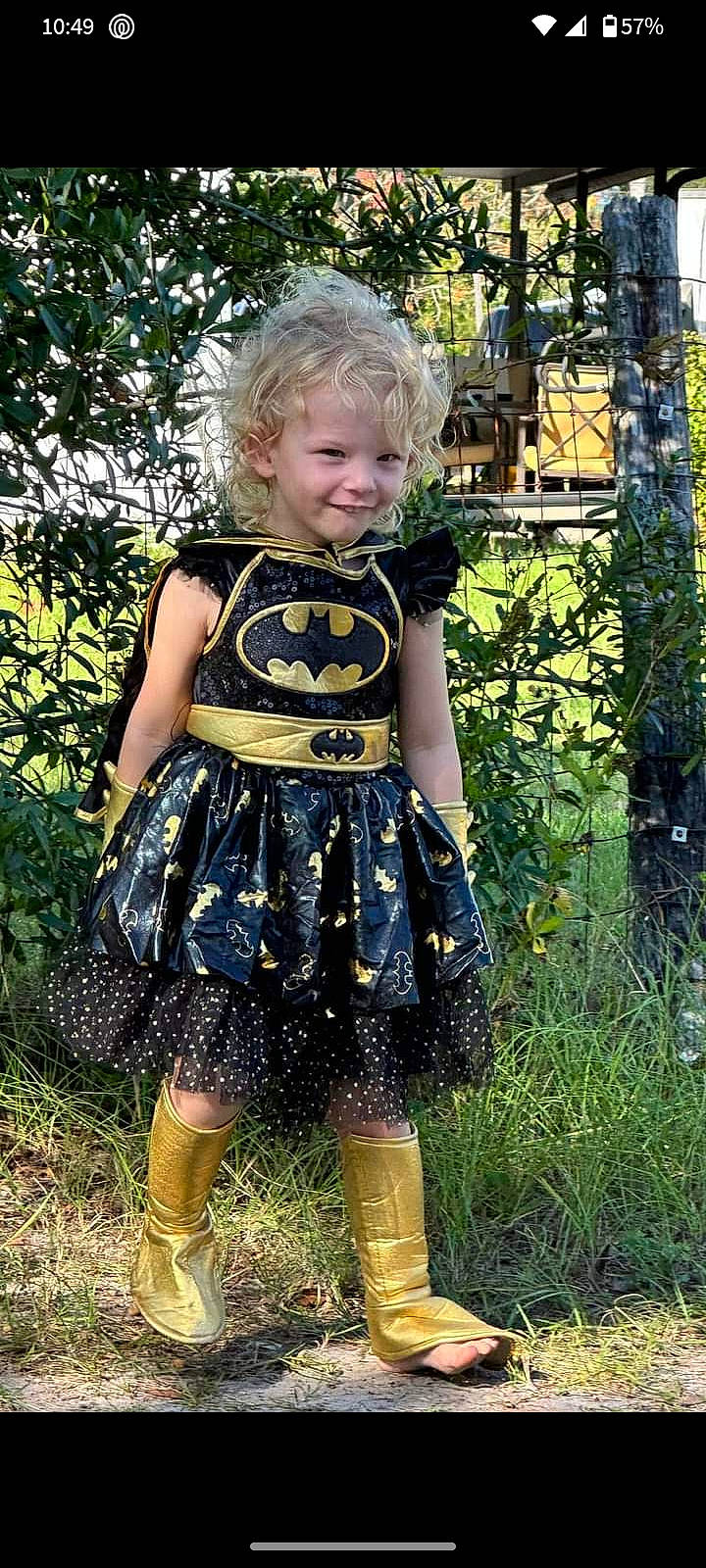 Adalyn is registered to the contest to win money with this photo: baby_toddler_clothing, blond, child, day_dress, electric_blue, garden, grass, happy, human_leg, joy, leaf, one_piece_garment, pattern, people_in_nature, person, plant, smile, toddler, tree, vintage_clothing