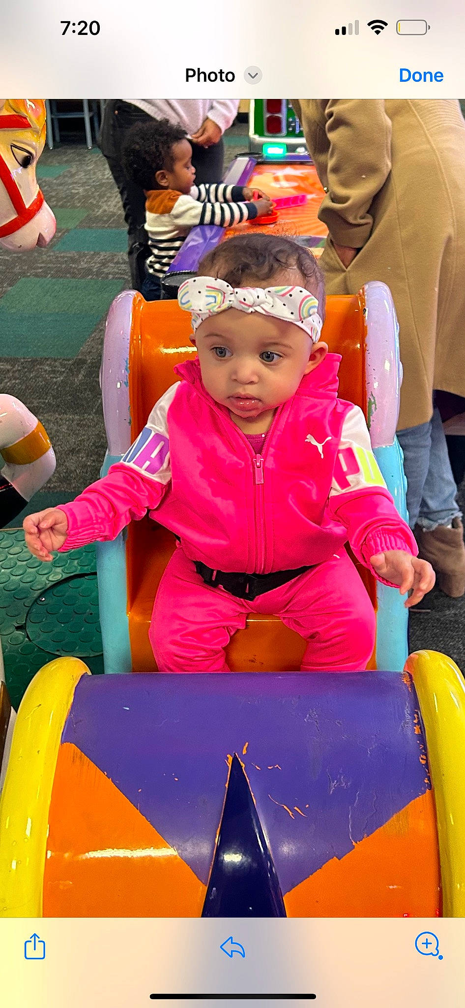 Xena is registered to the contest to win money with this photo: baby, cap, child, event, fun, happy, headwear, leisure, magenta, outdoor_play_equipment, outdoor_recreation, people, person, personal_protective_equipment, pink, play, playground, recreation, sitting, summer