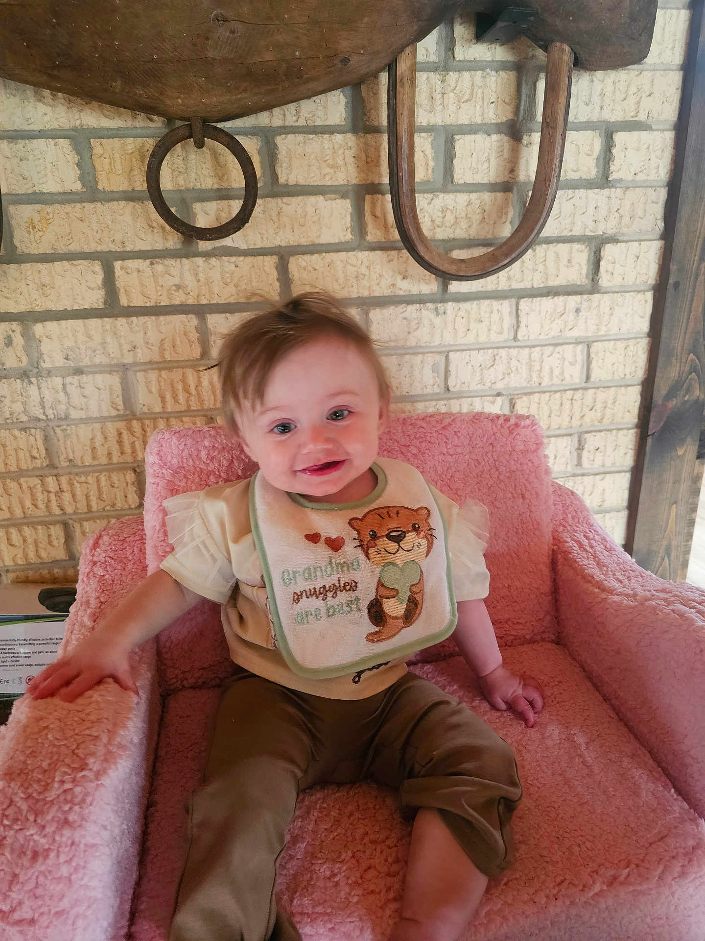 Emily joined the competition — help win amazing prizes! baby, bib, brick_wall, child, clothing, eyes, furniture, hair, hand, happy, home_interior, horseshoe, leg, pink_chair, plush_chair, portrait, ring, sitting, smile, wooden_decor