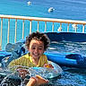 Adam joined the competition — help win amazing prizes! balcony, boats, child, curly_hair, happy, inflatable_ring, ocean, outdoor, pool, portrait, railing, seaside, smiling, splashing, summer, sunny, swimming, vacation, water, yellow_shirt