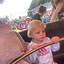 Kyra joined the competition — help win amazing prizes! toddler, child, carnival, ride, metal_bar, fairground, outdoor, daylight, people, woman, boy, clothing, casual, trees, fun, amusement_park, activity, adidas, curly_hair, holding