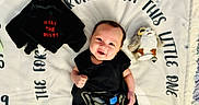 Elijah is registered to the contest to win money with this photo: baby, child, darth_vader, plush_toy, stuffed_animal, blanket, smiling, black_clothing, cute, lying_down, soft_texture, indoor, portrait, toy, star_wars, happy, face, infant, cozy, playful
