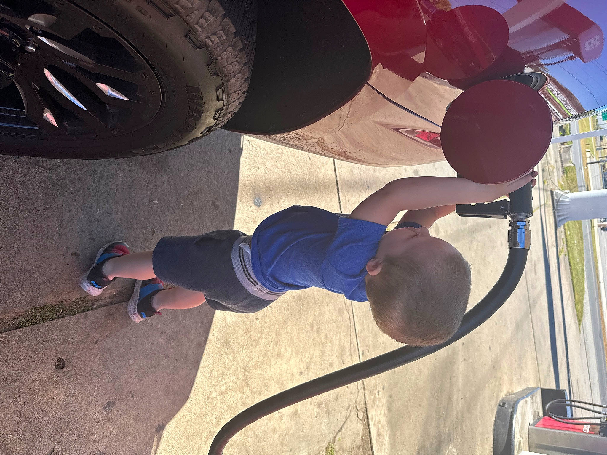 Jeremiah is registered to the contest to win money with this photo: auto_part, automotive_exterior, automotive_tire, automotive_wheel_system, elbow, fender, hat, knee, leg, motor_vehicle, person, rim, shoe, shorts, sneakers, synthetic_rubber, t_shirt, thigh, tire, tread