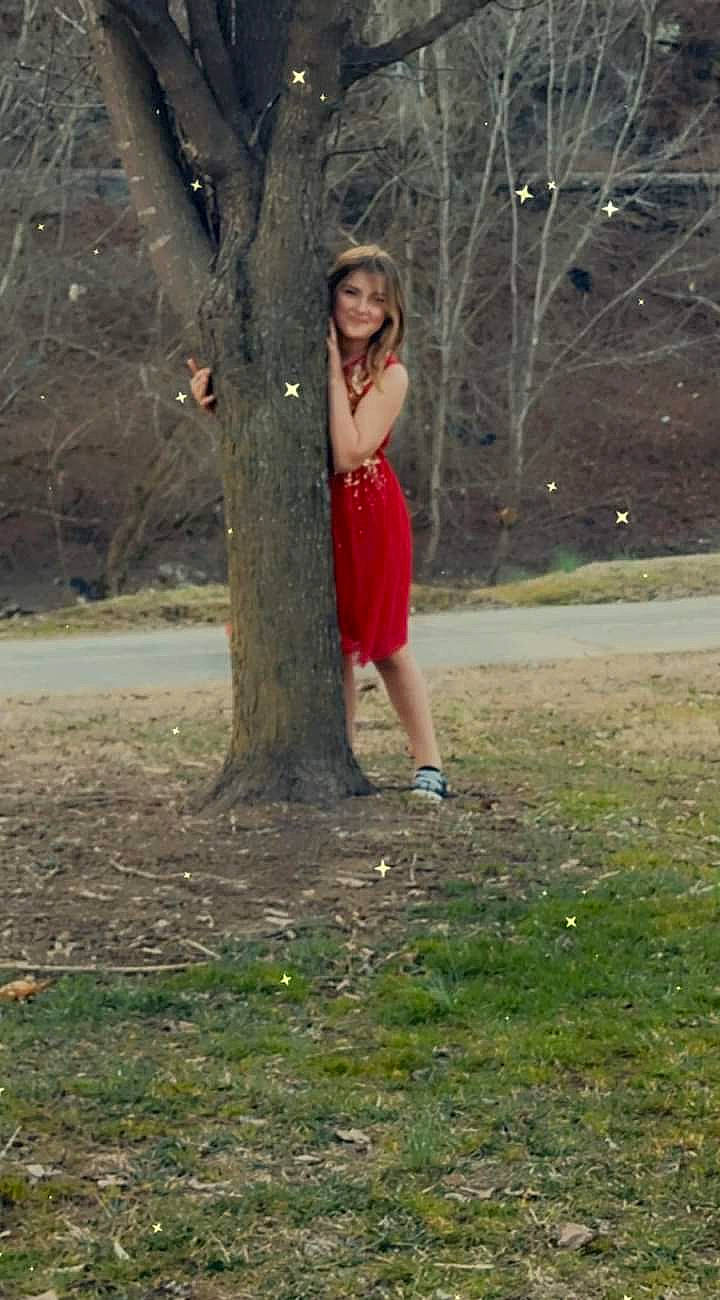 Kaelynn is registered to the contest to win money with this photo: branch, fawn, forest, grass, grass_family, happy, human_leg, joy, knee, leg, leisure, long_hair, people_in_nature, person, plant, thigh, tints_and_shades, tree, trunk, waist