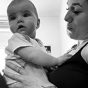 Adryanna participe au concours pour gagner de l'argent avec cette photo : baby, adult, black_and_white, tattoo, holding, indoor, person, child, face, portrait, curious, expression, hand, arm, clothing, window, light, skin, closeup, love