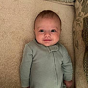 Jackson joined the competition — help win amazing prizes! baby, infant, smiling, green_onesie, carpet, cushion, blanket, indoors, child, person, cute, lying_down, happy, face, head, small_person, cozy, home, comfort, soft_texture
