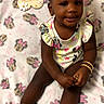 Ariis is registered to the contest to win money with this photo: baby, child, infant, girl, smile, sitting, blanket, minnie_mouse, clothing, footwear, jewelry, milestone, pink, cute, happy, indoors, portrait, accessories, toy, celebration