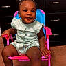 toddler, child, smiling, indoor, chair, clothing, romper, footwear, white_sandals, hair_accessories, carpet, furniture, drawer, happy, person, cute, sitting, baby, portrait, young_child