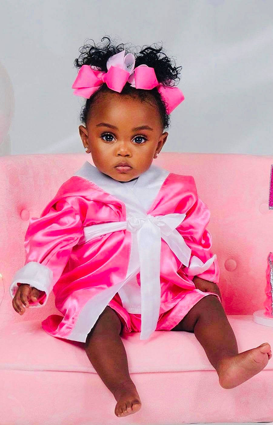 Sanaa is registered to the contest to win money with this photo: baby_toddler_clothing, cheek, child, chin, dress, eyelash, happy, headband, headpiece, human_leg, jewellery, lip, magenta, person, petal, pink, purple, skin, sleeve, thigh