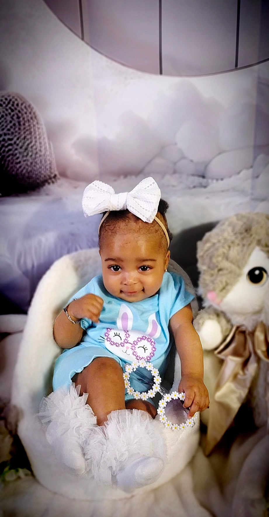 Aaliyah Taylor is registered to the contest to win money with this photo: baby, child, bow, blue_clothing, bunny_design, chair, cute, daisy_sunglasses, fluffy, girl, plush_toy, portrait, sitting, soft_texture, white_bow, white_chair, white_socks, adorable, indoor, infant