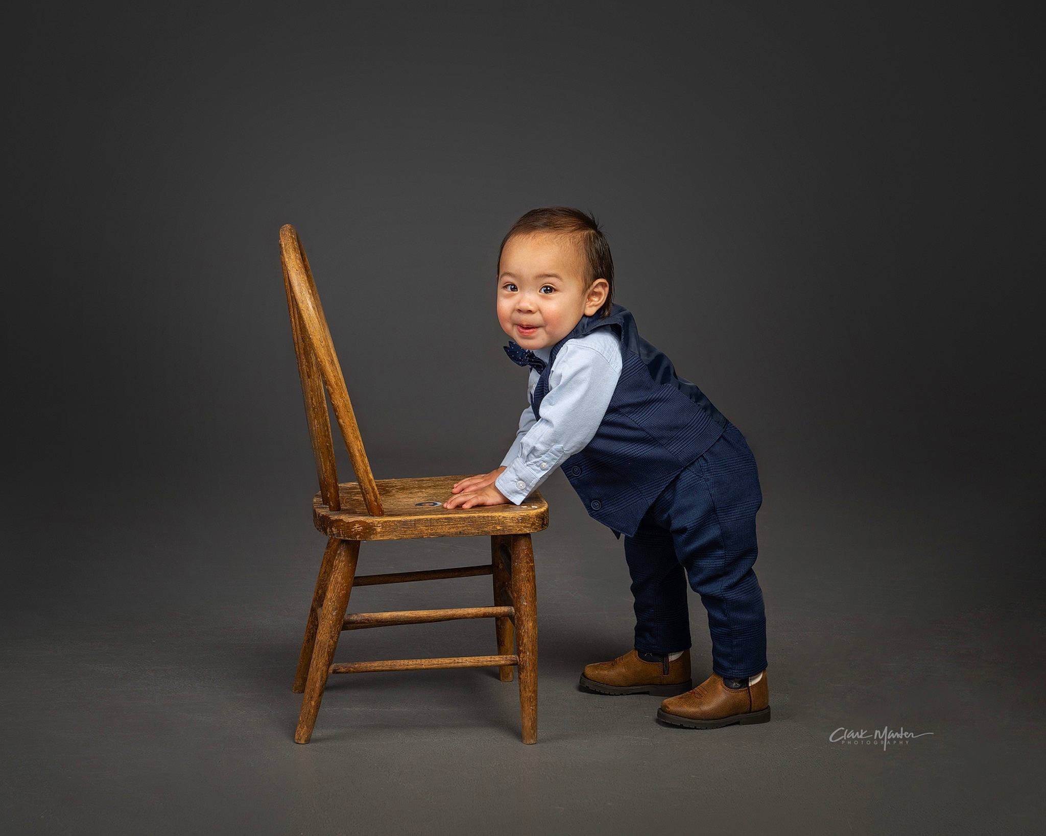 Dominic joined the competition — help win amazing prizes! arm, baby, chair, comfort, darkness, flash_photography, flooring, foot, gesture, jeans, leg, leisure, person, shoe, sitting, smile, sneakers, standing, table, toddler