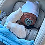 baby, newborn, car_seat, blanket, pacifier, hat, white_clothing, knitwear, sleeping, child, infant, seatbelt, cozy, cute, car_interior, comfort, soft, resting, headwear, bundle