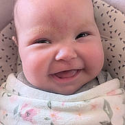 Ava is registered to the contest to win money with this photo: baby, smile, face, blanket, cozy, cute, child, infant, happy, wrapped, portrait, skin, cheeks, closeup, expression, young, soft, warm, indoors, clothing