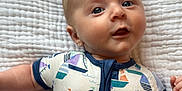 Lucas joined the competition — help win amazing prizes! baby, baby_face, blanket, blue_eyes, child, child_bedtime, clothing, curious_expression, cute, fabric, indoors, infant, lying_down, natural_light, onesie, portrait, sailboat_pattern, short_hair, small_hands, soft_texture