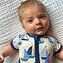 baby, baby_garment, blanket, blue_eyes, child, clothing, cute, face, hair, happy, infant, laying_down, onesie, portrait, sailboat_pattern, skin, smiling, soft_lighting, texture, young_child