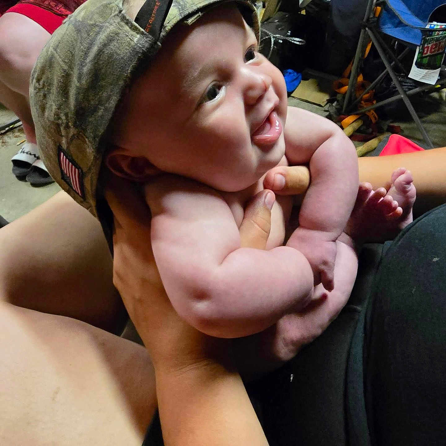 Olyvers is registered to the contest to win money with this photo: baby, child, smiling, hat, camo, cap, indoor, person, holding, hands, legs, toes, furniture, chair, bag, casual, happy, cute, portrait, infant
