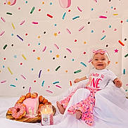 Finley is registered to the contest to win money with this photo: baby, baseball, birthdaycake, bodypart, cake, clothing, cream, dessert, face, finger, food, furniture, hand, hat, head, people, person, photography, portrait, sweets