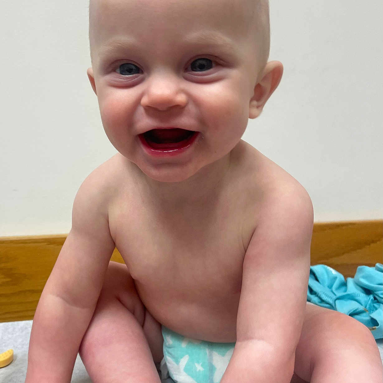 Axel is registered to the contest to win money with this photo: baby, babylaughing, bodypart, clothing, diaper, dress, face, finger, hand, happy, head, laughing, newborn, person, photography, portrait, sitting, smile