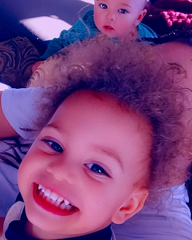 Jordan is registered to the contest to win money with this photo: blue, cheek, chin, ear, eye, eyebrow, eyelash, face, facial_expression, forehead, happy, headwear, joy, light, lip, mouth, nose, organ, person, purple