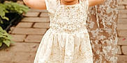 Diem joined the competition — help win amazing prizes! child, toddler, holding_hands, orange_bow, floral_dress, adult, walking, outdoor, cobblestone, plants, sandals, smiling, cute, person, family, summer, happy, fashion, footwear, nature