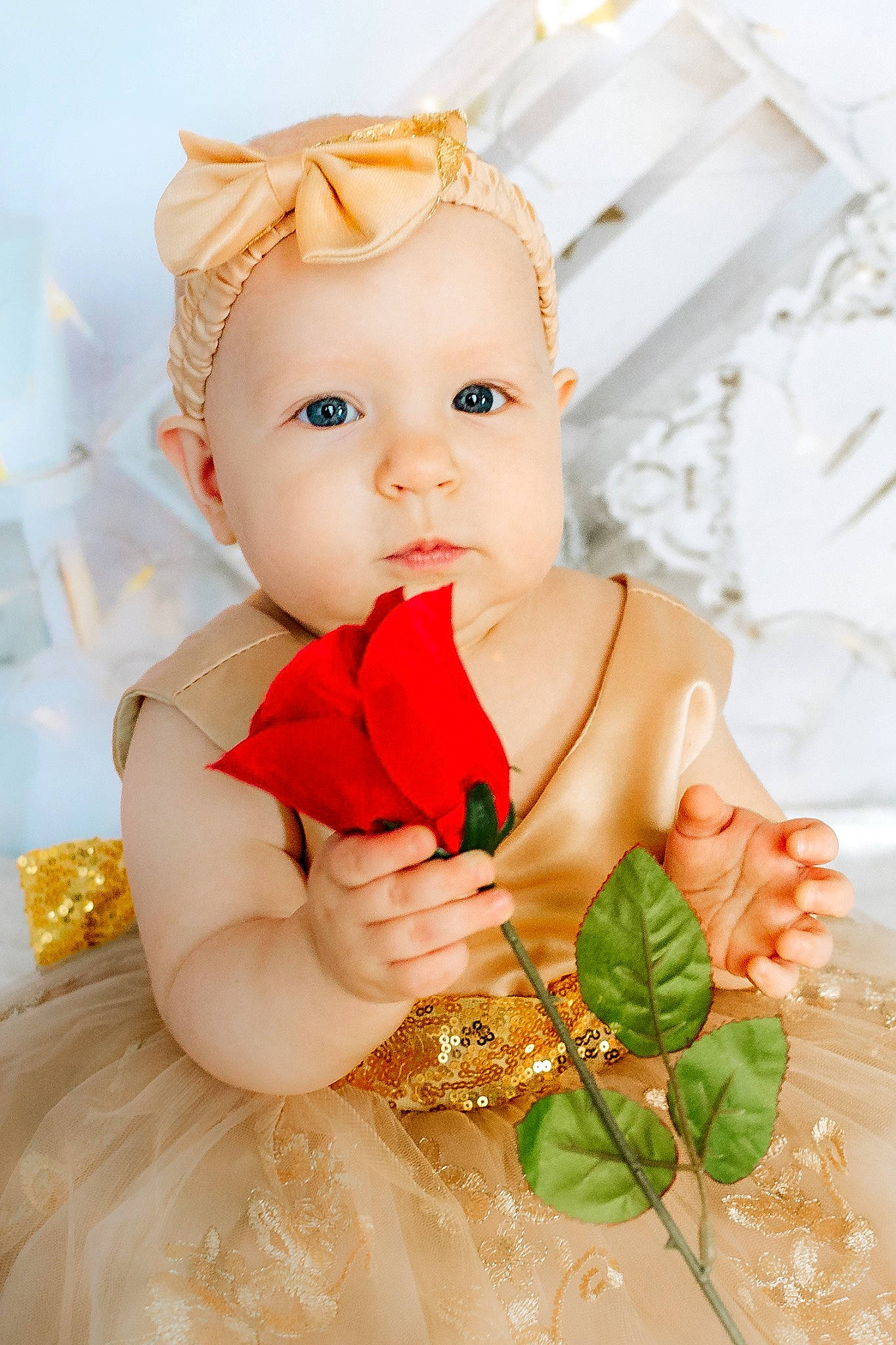 Diem is registered to the contest to win money with this photo: baby, baby_toddler_clothing, child, dress, event, facial_expression, fashion_accessory, hair_accessory, happy, headpiece, jewellery, peach, person, petal, pink, rose, skin, textile, toddler, toy