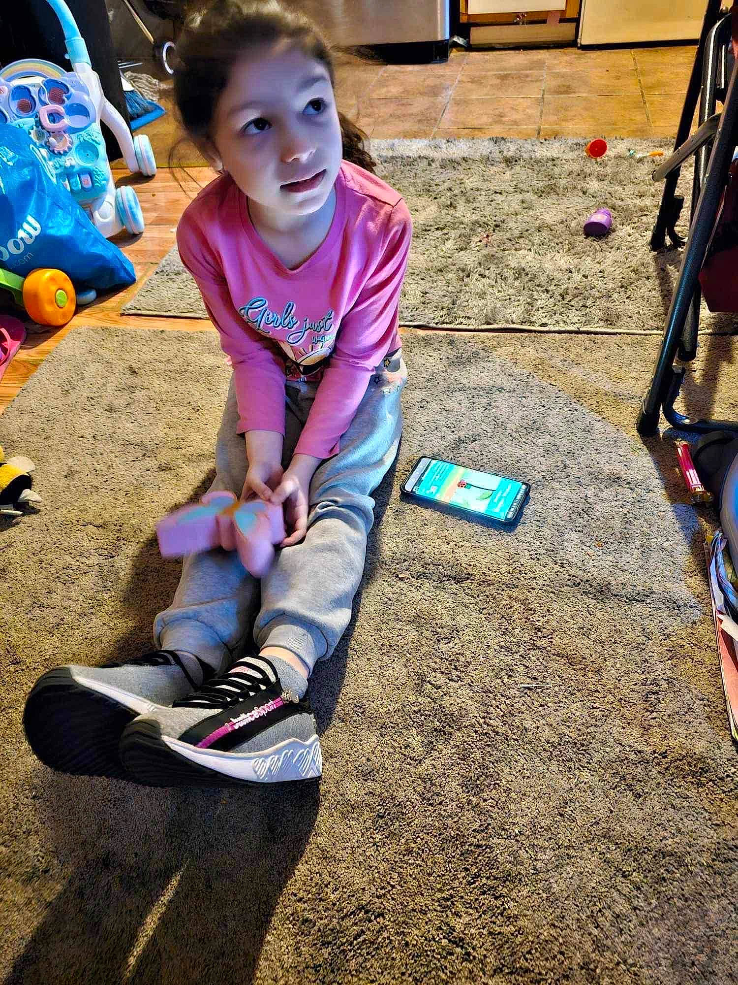 Bella joined the competition — help win amazing prizes! beauty, child, city, fun, grass, hairstyle, happy, human_leg, knee, leisure, outdoor_shoe, person, recreation, sand, shorts, sitting, smile, sneakers, thigh, toddler