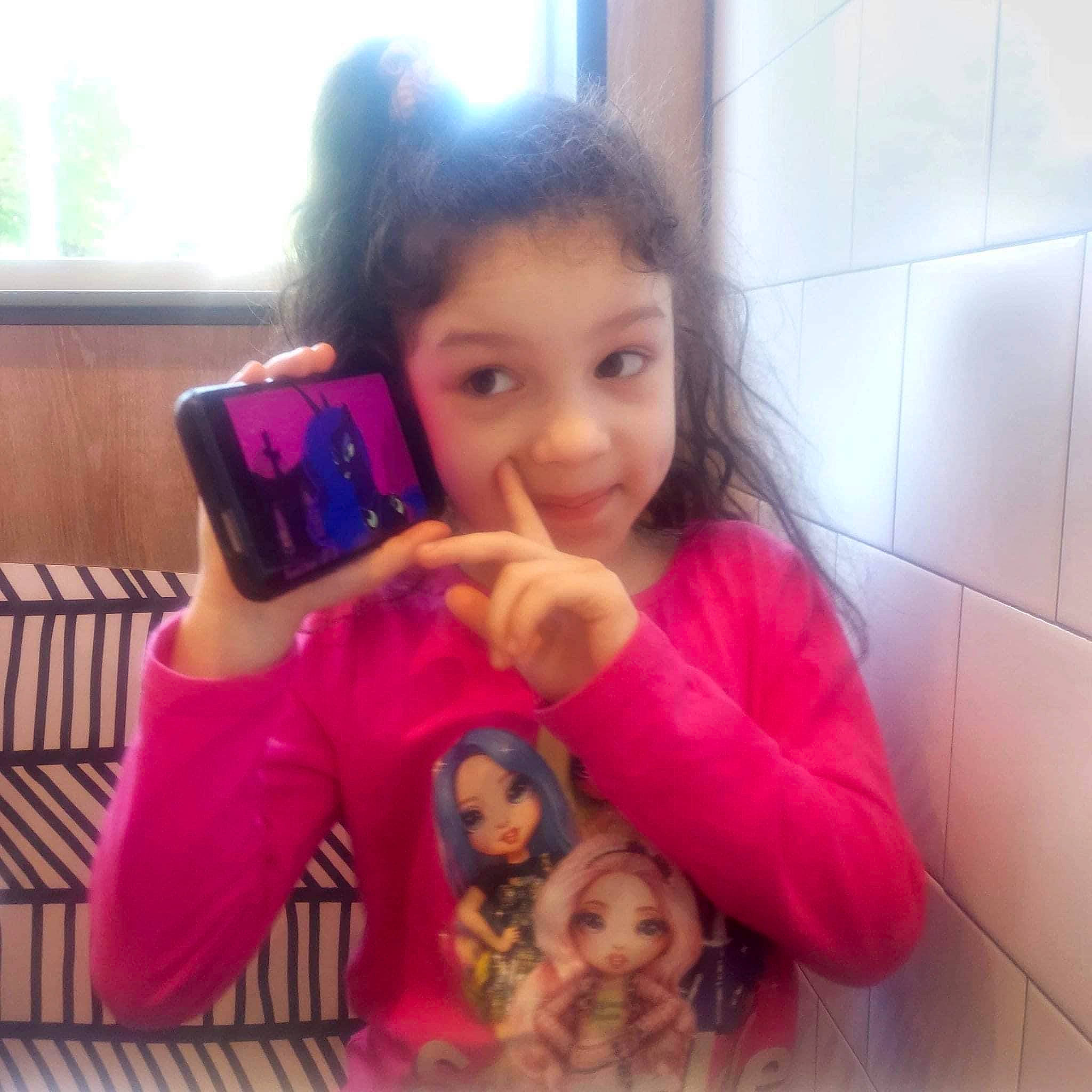 Bella joined the competition — help win amazing prizes! black_hair, child, cool, ear, eyelash, facial_expression, finger, fun, hair, happy, joy, lip, mouth, nose, person, pink, skin, sleeve, smile, thumb