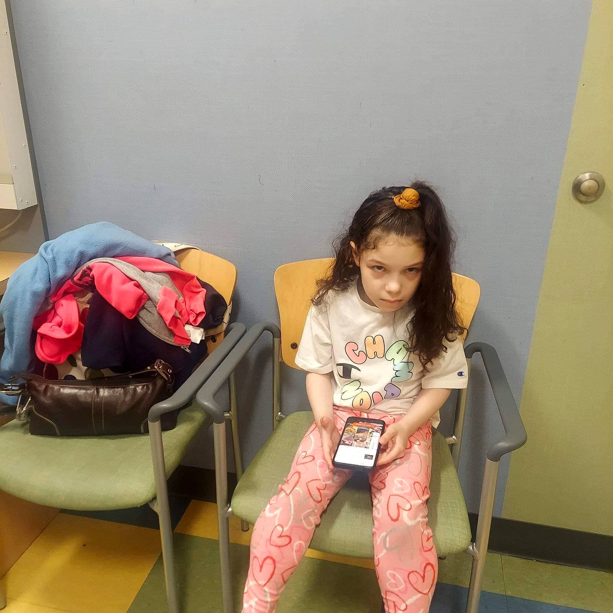 Bella is registered to the contest to win money with this photo: backpack, bag, chair, comfort, fashion_design, flooring, human_leg, joint, knee, leg, leisure, luggage_and_bags, magenta, person, pink, room, shoulder, sitting, sleeve, thigh