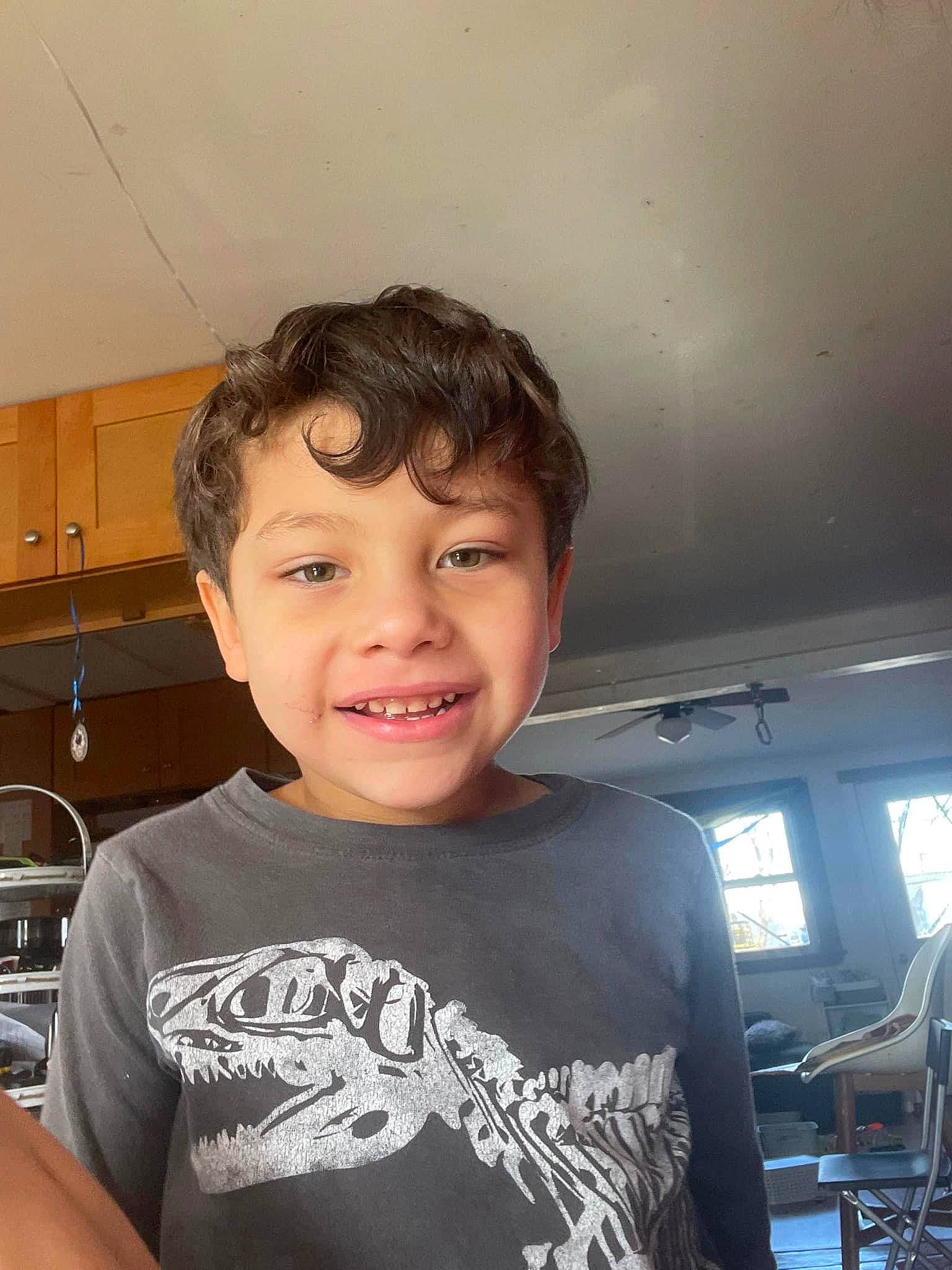 Anthony is registered to the contest to win money with this photo: black_hair, chair, cheek, child, cool, eyelash, flash_photography, forehead, fun, happy, jaw, joy, kitchen_appliance, person, portrait_photography, room, sitting, sleeve, smile, t_shirt