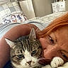 Jake is registered to the contest to win money with this photo: cat, tabby_cat, pet, person, red_hair, hugging, cuddling, selfie, face, whiskers, green_eyes, paws, bedroom, bed, blanket, pillow, bedspread, television, dresser, indoor