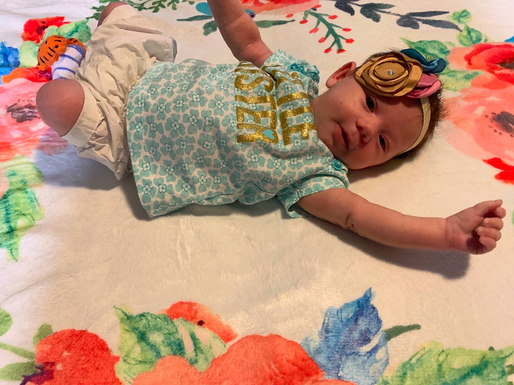 Mindy is registered to the contest to win money with this photo: adaptation, art, baby, baby_toddler_clothing, child, finger, flooring, flower, fun, green, hand, linens, pattern, person, petal, play, room, t_shirt, textile, toddler