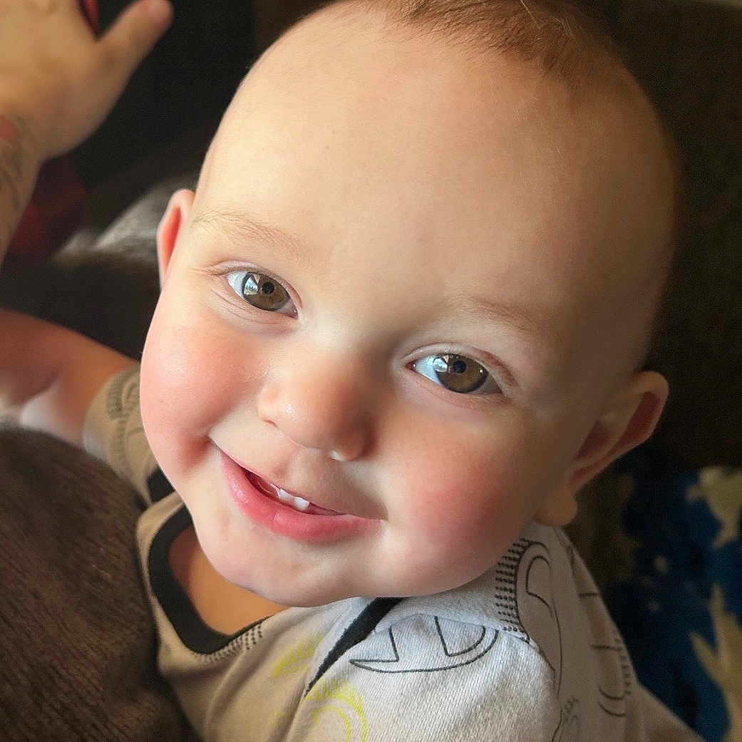 Kelly is registered to the contest to win money with this photo: baby, child, smiling, face, portrait, cute, infant, happy, toddler, clothing, short_sleeves, skin, head, eyes, indoor, light, person, expression, cheeks, hair