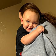 Kelly is registered to the contest to win money with this photo: adult, baby, black_shirt, child, closeup, cuddle, face, family, gray_shirt, happy, hugging, indoor, infant, parent, person, portrait, smiling, warm_lighting, 抱抱