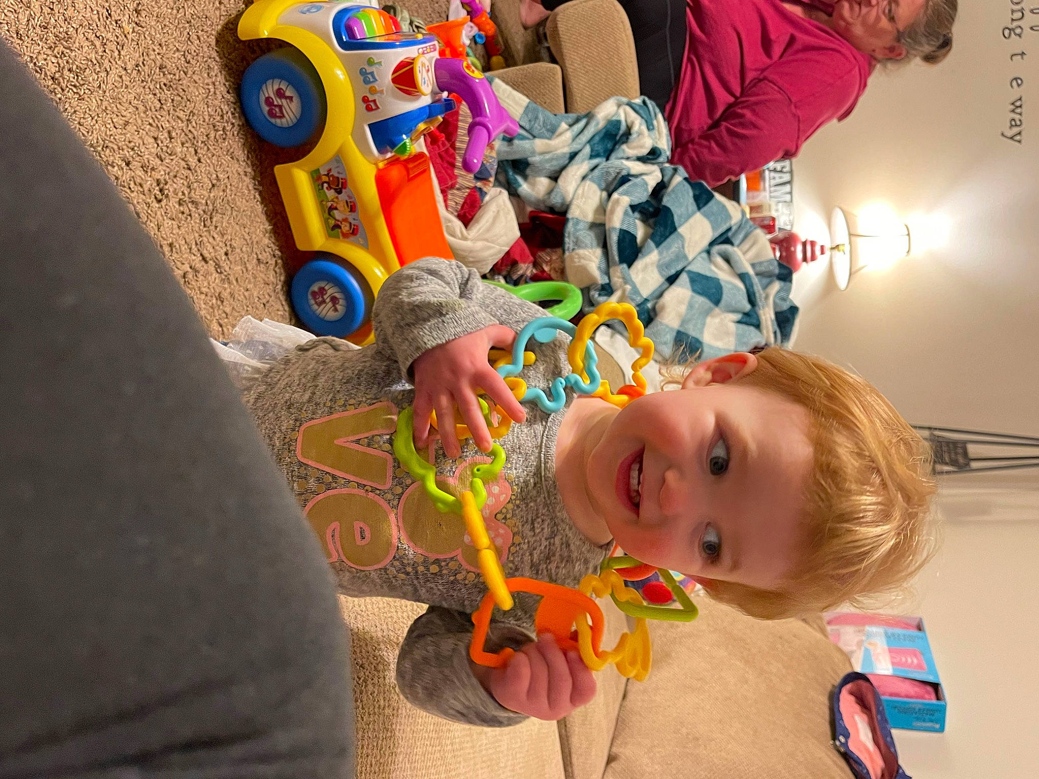 Braelynn is registered to the contest to win money with this photo: baby, baby_toys, child, flooring, fun, happy, joy, leisure, person, plastic, play, room, sitting, smile, t_shirt, tire, toddler, toy, vacation, visual_arts