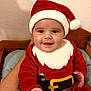 Tino participe au concours pour gagner de l'argent avec cette photo : baby, blanket, child, christmas, cute, face, festive, hand, happy, hat, holiday, indoor, infant, person, portrait, red_clothing, santa_claus_costume, smile, wall, wood