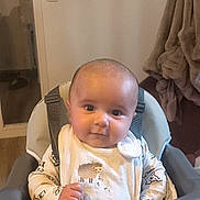 Tino participe au concours pour gagner de l'argent avec cette photo : baby, bib, blanket, child, clothing, curious, cute, face, furniture, high_chair, home, indoor, infant, person, portrait, seated, sheep_design, smiling, soft_lighting, young