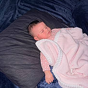 Iyla joined the competition — help win amazing prizes! baby, baby_clothing, bed, blanket, closed_eyes, cozy, dark_background, floral_pattern, indoors, infant, nap, newborn, peaceful, photography, pillow, pink_blanket, portrait, resting, sleeping, soft_texture