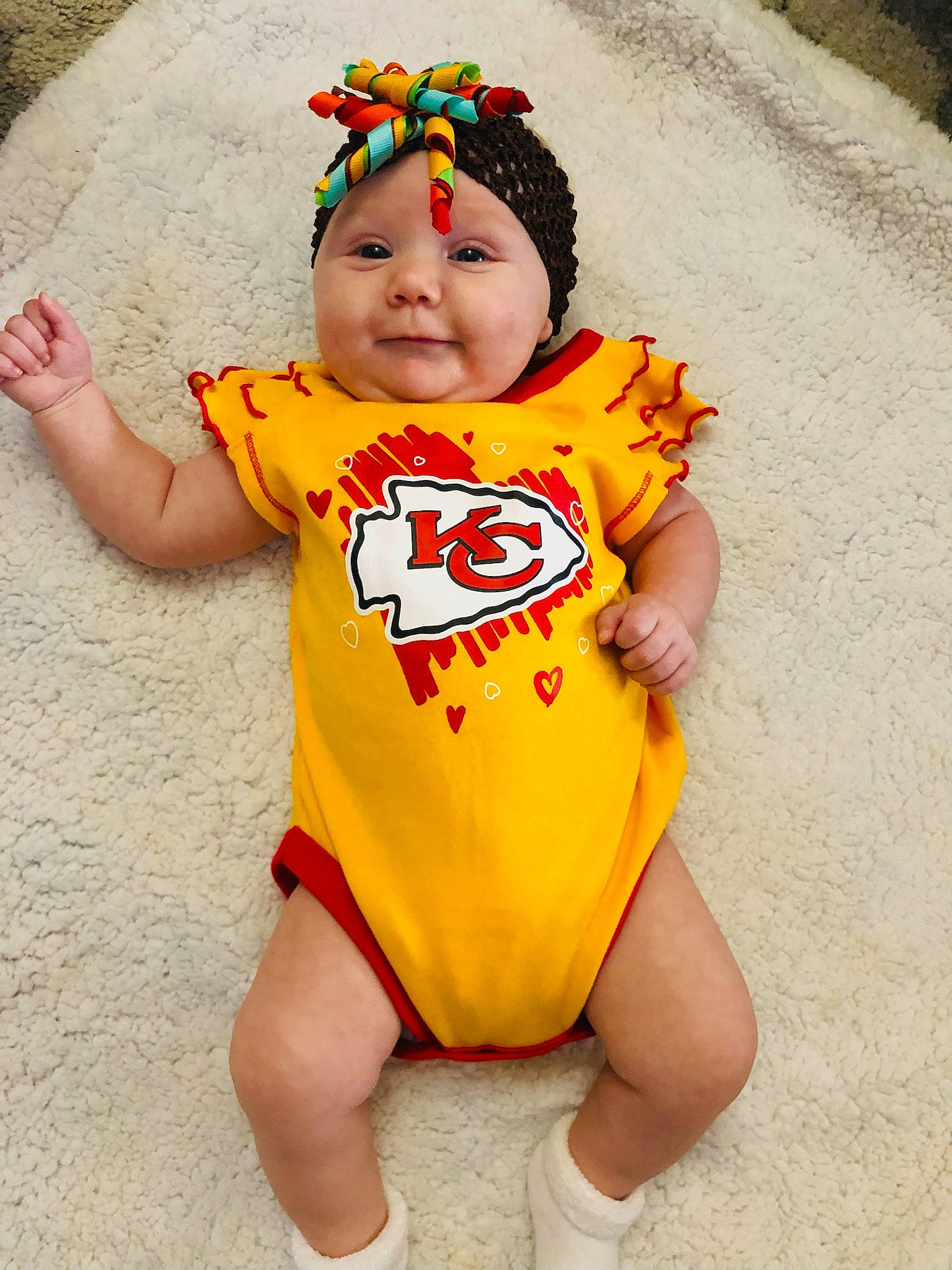 Alyaa is registered to the contest to win money with this photo: baby, baby_products, baby_toddler_clothing, beanie, cap, child, eye, fun, happy, headgear, headwear, orange, organ, pattern, people, person, personal_protective_equipment, sleeve, t_shirt, thigh