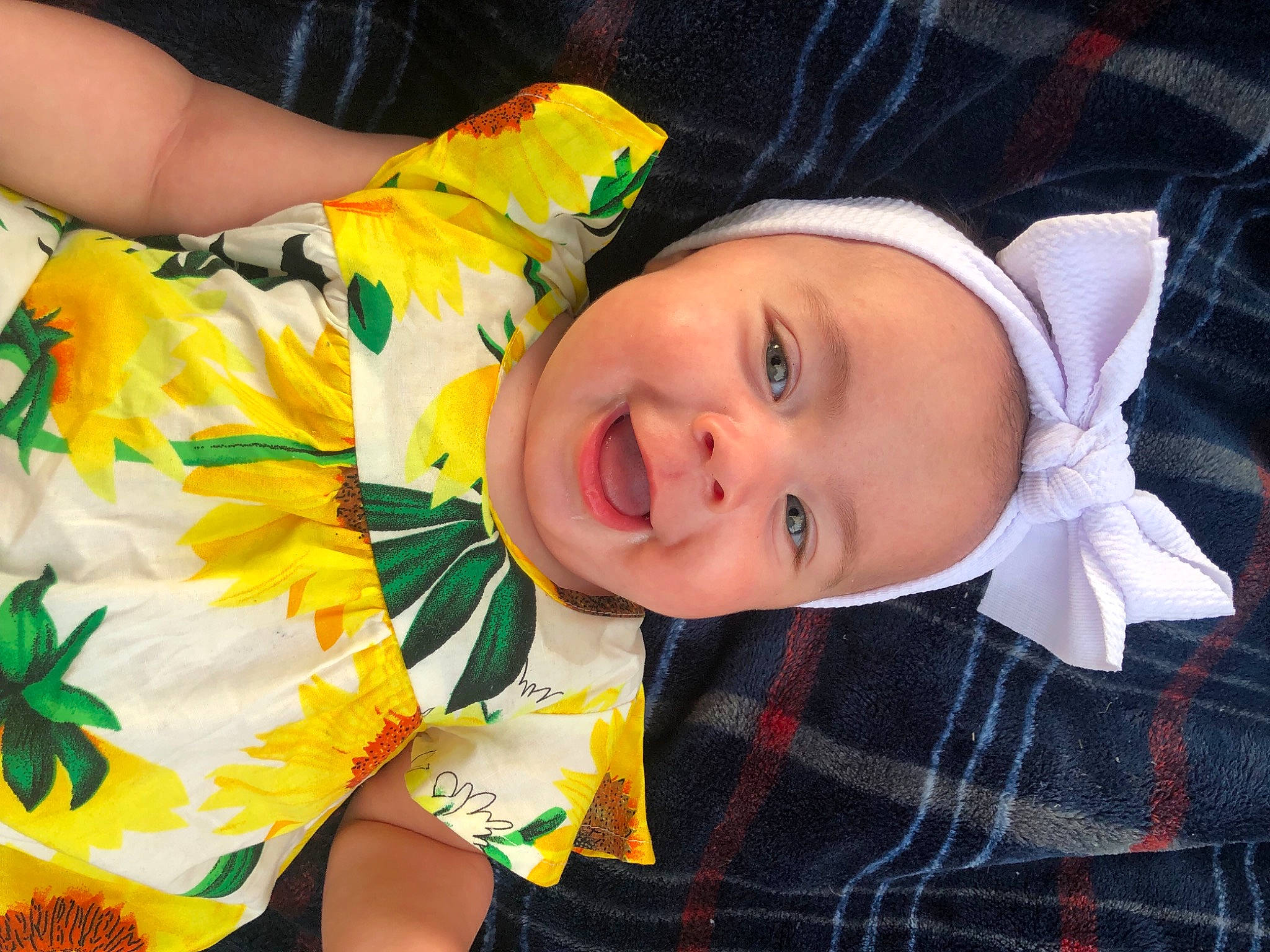 Madalynn is registered to the contest to win money with this photo: baby_toddler_clothing, cheek, child, eye, face, facial_expression, happy, head, iris, leaf, lip, nose, person, product, skin, sleeve, smile, tartan, textile, toddler